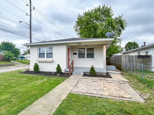 1653 Wade St, Indianapolis, IN 46203 - view of front of home featuring brick siding and covered porch