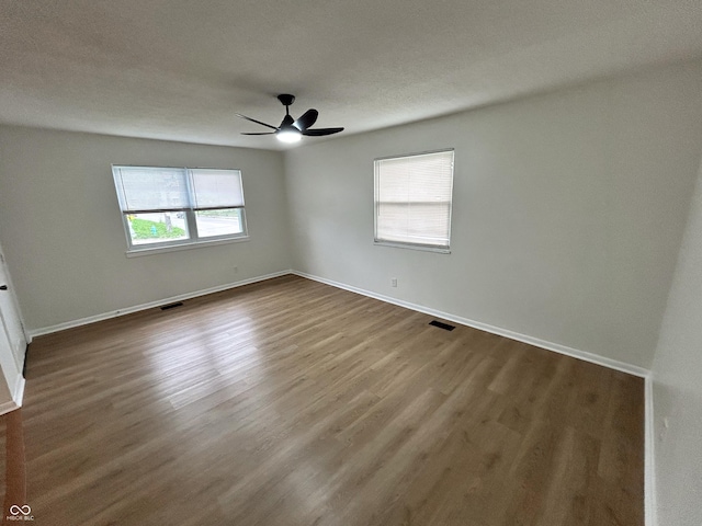 1653 Wade St, Indianapolis, IN 46203 - empty room featuring ceiling fan, dark wood finished floors, and baseboards