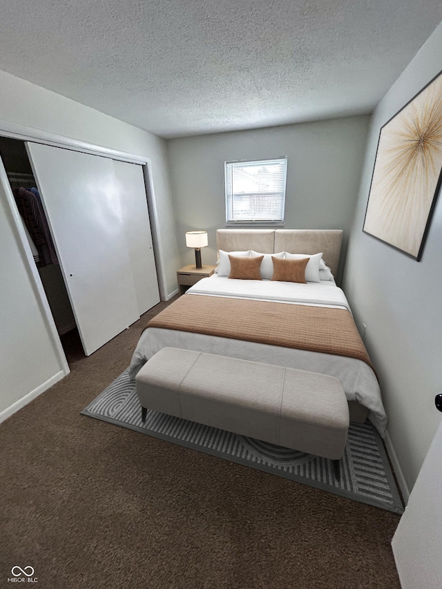 1653 Wade St, Indianapolis, IN 46203 - carpeted bedroom featuring a textured ceiling, a closet, and baseboards