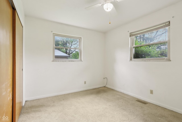 410 E Southport Rd, Indianapolis, IN 46227 - unfurnished bedroom with multiple windows, carpet floors, baseboards, and a closet