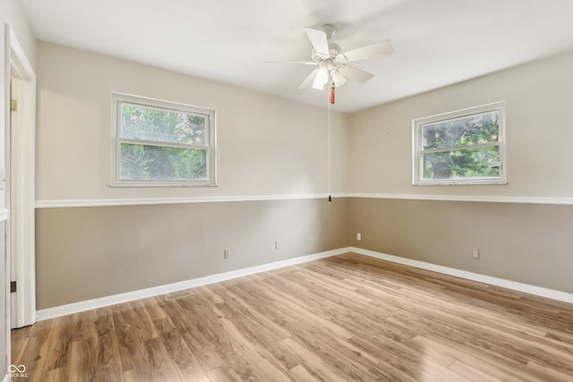 410 E Southport Rd, Indianapolis, IN 46227 - spare room featuring wood finished floors, baseboards, and ceiling fan
