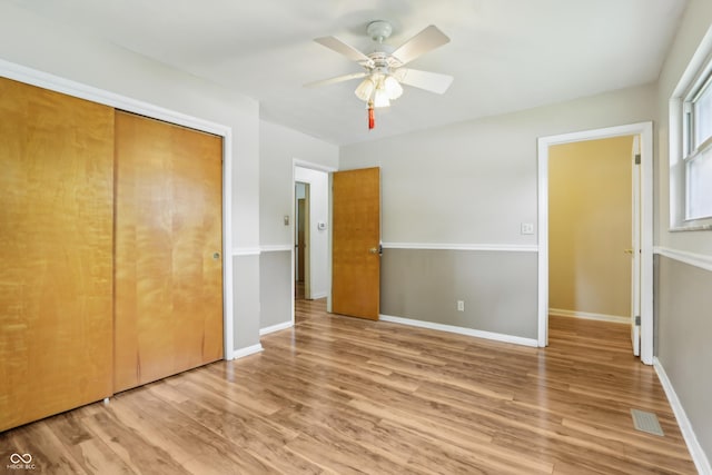 410 E Southport Rd, Indianapolis, IN 46227 - unfurnished bedroom with wood finished floors, a closet, a ceiling fan, and baseboards