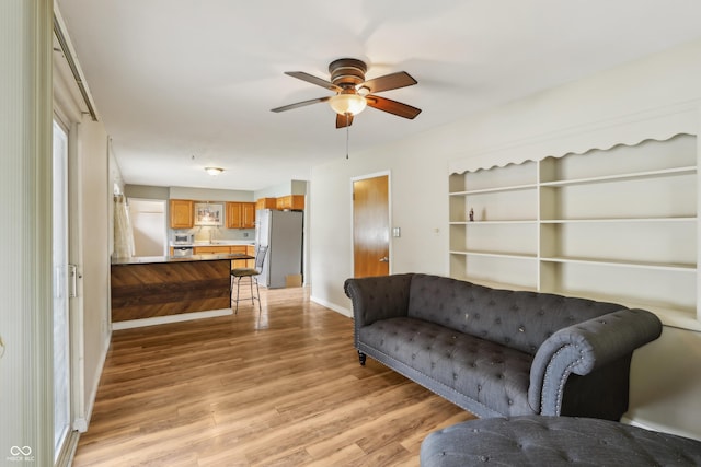 410 E Southport Rd, Indianapolis, IN 46227 - living room with light wood-style flooring, a ceiling fan, and baseboards