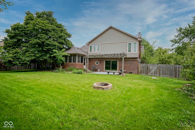 4949 Jennings Dr, Carmel, IN 46033 - back of house featuring an outdoor fire pit, a pergola, brick siding, a patio area, and a sunroom