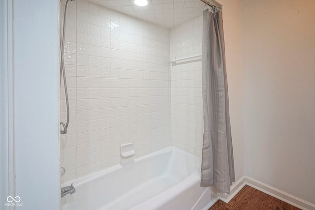 4949 Jennings Dr, Carmel, IN 46033 - full bath with shower / bath combo with shower curtain, baseboards, and wood finished floors
