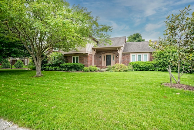 4949 Jennings Dr, Carmel, IN 46033 - view of front of house with brick siding, a front yard, and roof with shingles