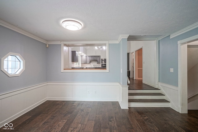 4949 Jennings Dr, Carmel, IN 46033 - empty room featuring dark wood-type flooring, ornamental molding, a textured ceiling, and wainscoting