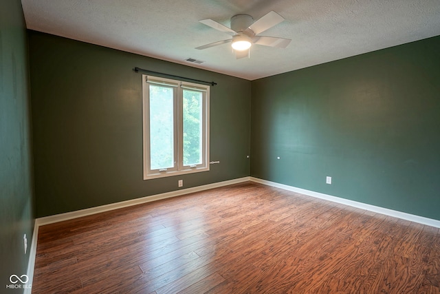 4949 Jennings Dr, Carmel, IN 46033 - empty room with wood finished floors, ceiling fan, a textured ceiling, and baseboards