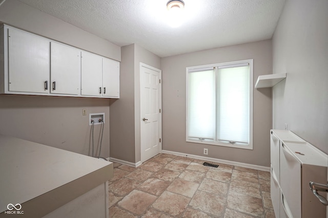 4949 Jennings Dr, Carmel, IN 46033 - washroom featuring cabinet space, a textured ceiling, baseboards, hookup for a washing machine, and light stone finish flooring