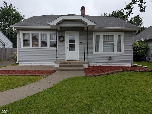 1728 Newton St, Columbus, IN 47201 - view of front of home featuring a chimney, roof with shingles, and cooling unit