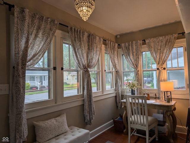 1728 Newton St, Columbus, IN 47201 - sunroom featuring wood finished floors, healthy amount of natural light, baseboards, and a chandelier