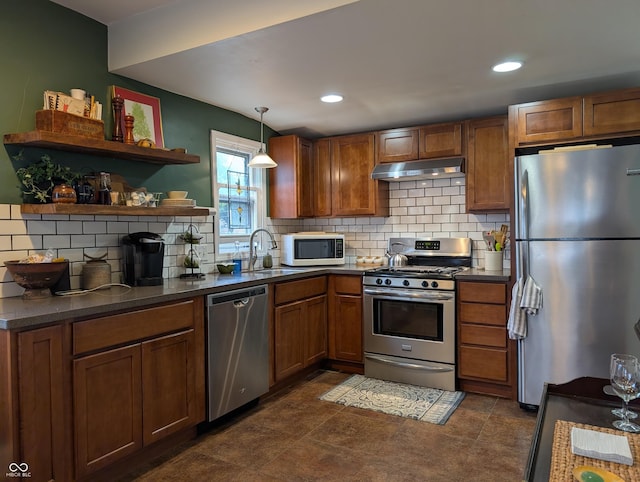 1728 Newton St, Columbus, IN 47201 - kitchen with stainless steel appliances, under cabinet range hood, dark countertops, brown cabinets, and decorative backsplash