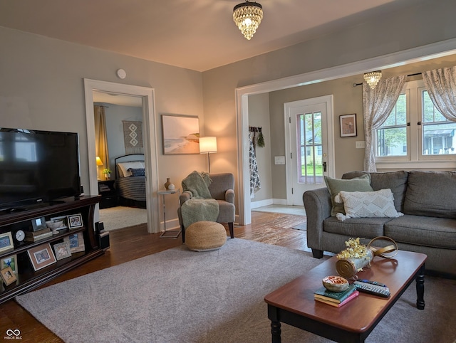 1728 Newton St, Columbus, IN 47201 - living area with wood finished floors, a chandelier, and baseboards
