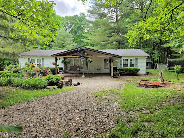 8310 Dog Trot Ln, Morgantown, IN 46160 - back of house featuring driveway and a trampoline