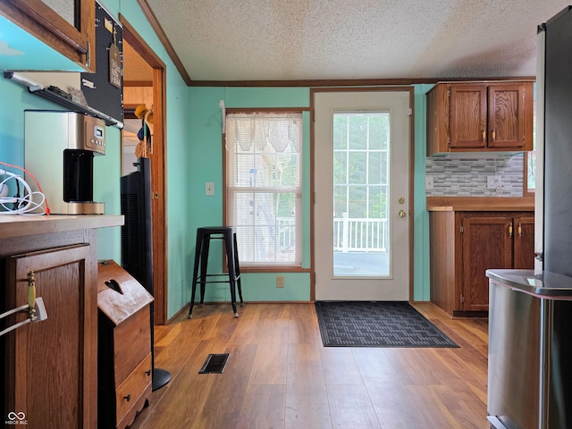 8310 Dog Trot Ln, Morgantown, IN 46160 - doorway with a textured ceiling and light wood-type flooring