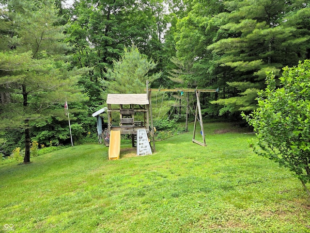 8310 Dog Trot Ln, Morgantown, IN 46160 - view of green lawn with a playground and a forest view