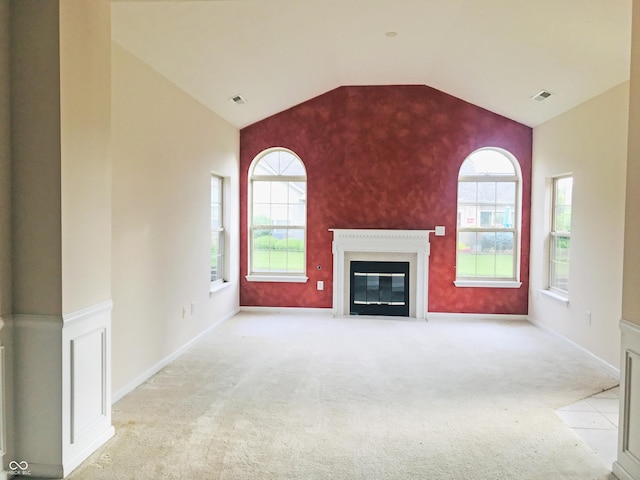 855 Gazebo Way Unit C, Greenwood, IN 46142 - unfurnished living room with carpet flooring, healthy amount of natural light, a fireplace with flush hearth, and lofted ceiling