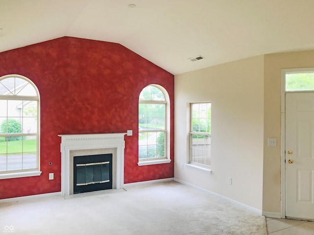 855 Gazebo Way Unit C, Greenwood, IN 46142 - unfurnished living room featuring vaulted ceiling, carpet floors, and a fireplace with flush hearth