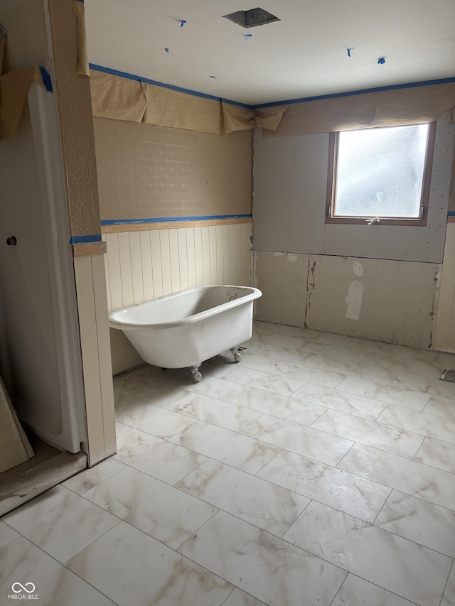 3526 Evergreen Ave, Indianapolis, IN 46205 - full bath featuring a soaking tub, marble finish floors, and a wainscoted wall