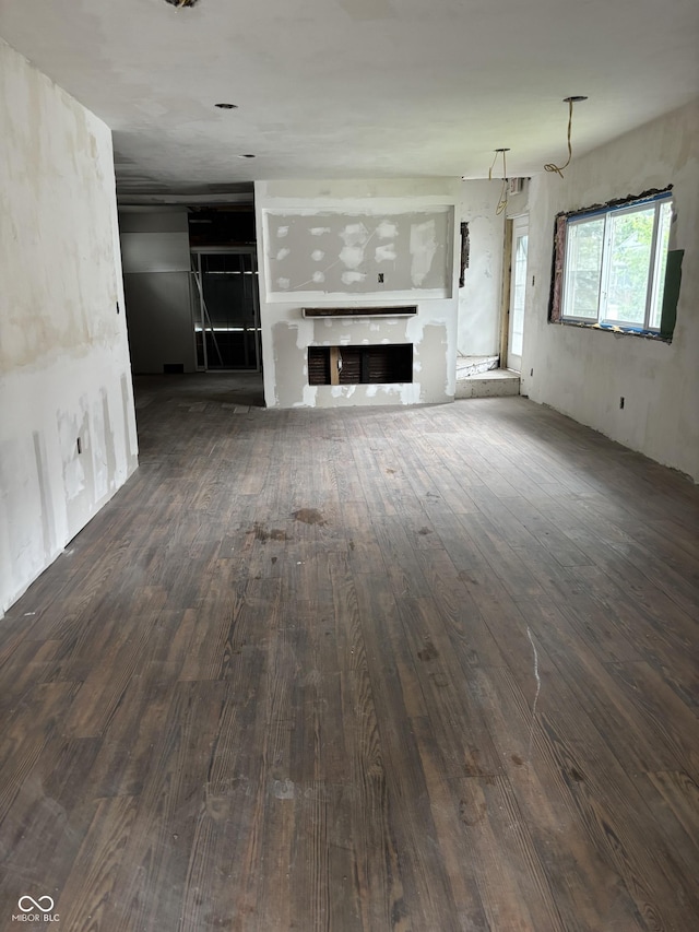 3526 Evergreen Ave, Indianapolis, IN 46205 - unfurnished living room featuring hardwood / wood-style floors and a fireplace