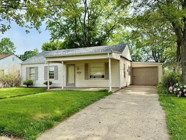 910 Lonsvale Dr, Anderson, IN 46013 - view of front of property with a front yard, an attached garage, concrete driveway, and a shingled roof