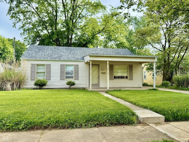 910 Lonsvale Dr, Anderson, IN 46013 - view of front of house with a front yard, a shingled roof, and a porch