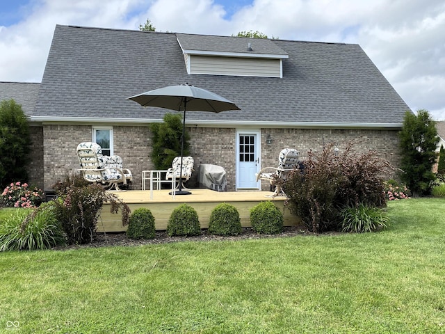 1135 W Wildflower Ct, Mooresville, IN 46158 - rear view of property with a deck, a shingled roof, a yard, and brick siding