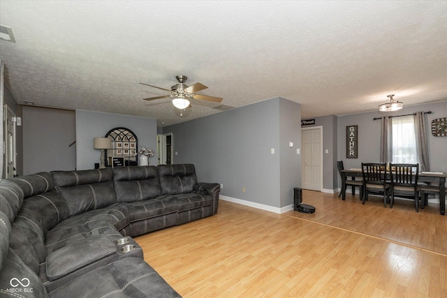 1135 W Wildflower Ct, Mooresville, IN 46158 - living area featuring wood finished floors, ceiling fan, baseboards, and a textured ceiling