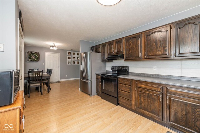 1135 W Wildflower Ct, Mooresville, IN 46158 - kitchen with stainless steel appliances, range hood, light wood-style floors, dark brown cabinets, and a textured ceiling