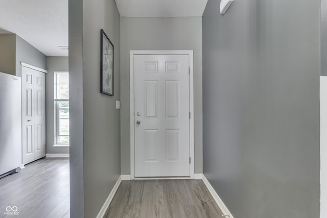 933 Curlew Ln, Greenwood, IN 46143 - entryway featuring wood finished floors, baseboards, and a textured ceiling