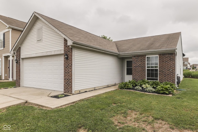 933 Curlew Ln, Greenwood, IN 46143 - view of front of home with brick siding, a garage, driveway, and a front lawn