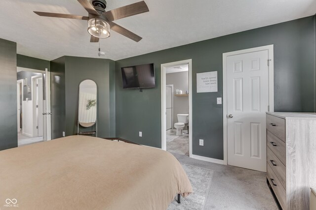 933 Curlew Ln, Greenwood, IN 46143 - bedroom featuring ensuite bath, baseboards, light colored carpet, and a ceiling fan