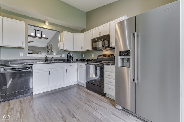 933 Curlew Ln, Greenwood, IN 46143 - kitchen with black appliances, dark countertops, white cabinetry, and a sink