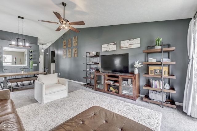 933 Curlew Ln, Greenwood, IN 46143 - carpeted living area featuring vaulted ceiling, a ceiling fan, baseboards, and a chandelier