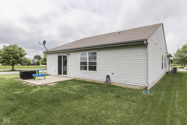 933 Curlew Ln, Greenwood, IN 46143 - back of property featuring central air condition unit, a patio area, and a yard