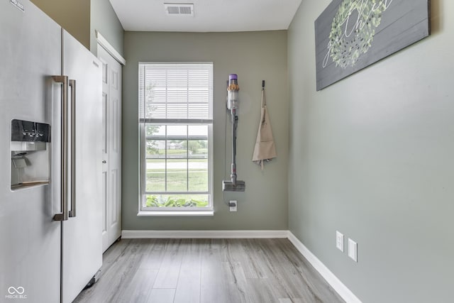 933 Curlew Ln, Greenwood, IN 46143 - unfurnished dining area featuring light wood-style flooring and baseboards