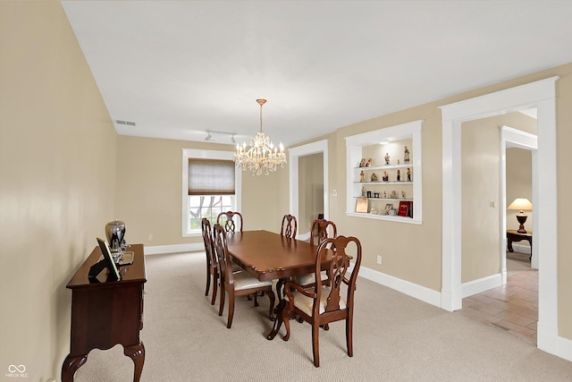 203 N Cross St, Hillsboro, IN 47949 - dining area featuring a chandelier, light carpet, and built in features