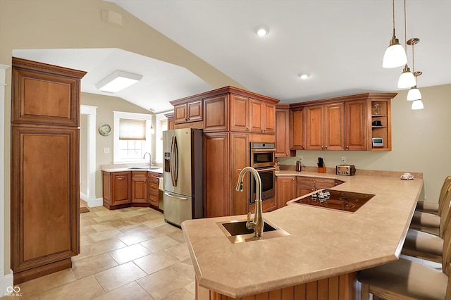 203 N Cross St, Hillsboro, IN 47949 - kitchen featuring stainless steel appliances, vaulted ceiling, a peninsula, brown cabinetry, and a kitchen breakfast bar