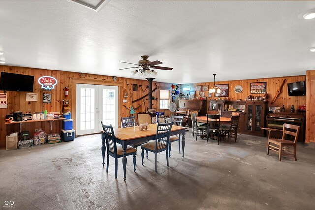 203 N Cross St, Hillsboro, IN 47949 - dining space with wooden walls, unfinished concrete floors, and a ceiling fan