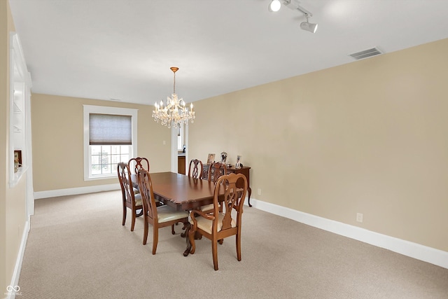 203 N Cross St, Hillsboro, IN 47949 - dining room with a chandelier, light carpet, and rail lighting