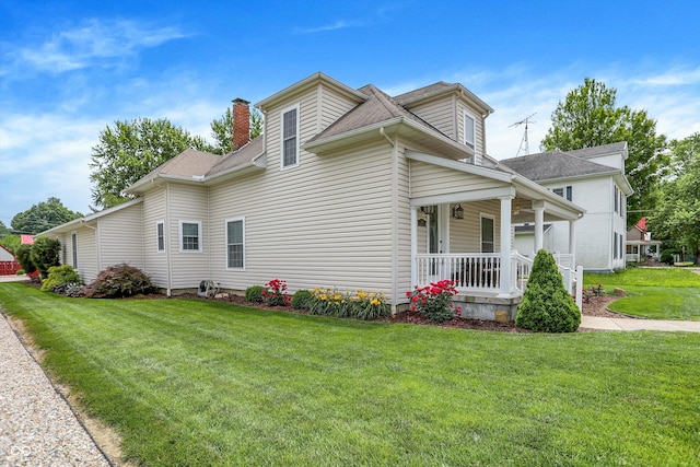 203 N Cross St, Hillsboro, IN 47949 - view of home's exterior featuring covered porch, a lawn, a chimney, and roof with shingles