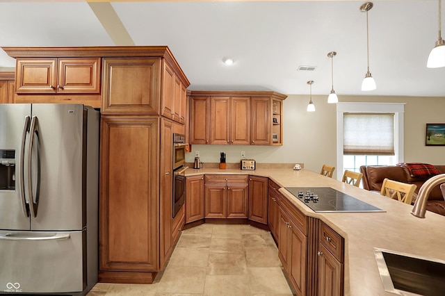 203 N Cross St, Hillsboro, IN 47949 - kitchen with appliances with stainless steel finishes, light countertops, brown cabinetry, and hanging light fixtures