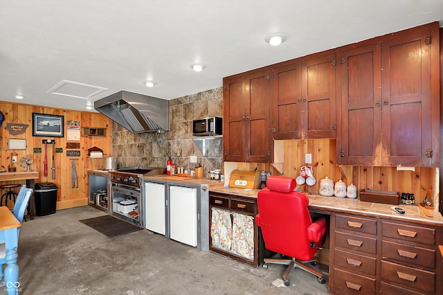 203 N Cross St, Hillsboro, IN 47949 - kitchen with wall chimney range hood, unfinished concrete floors, light countertops, wood walls, and a desk