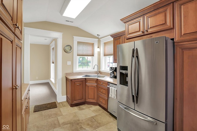 203 N Cross St, Hillsboro, IN 47949 - kitchen featuring appliances with stainless steel finishes, lofted ceiling, brown cabinets, light countertops, and pendant lighting