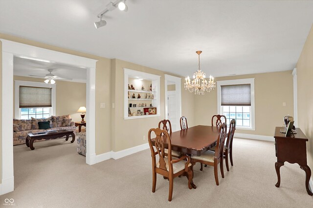 203 N Cross St, Hillsboro, IN 47949 - dining area featuring light colored carpet, a chandelier, track lighting, ceiling fan, and built in shelves
