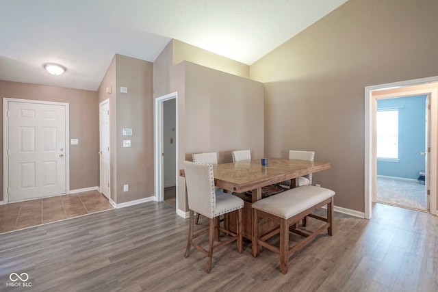 7724 Blackthorn Dr, Indianapolis, IN 46236 - dining room with baseboards, vaulted ceiling, and wood finished floors