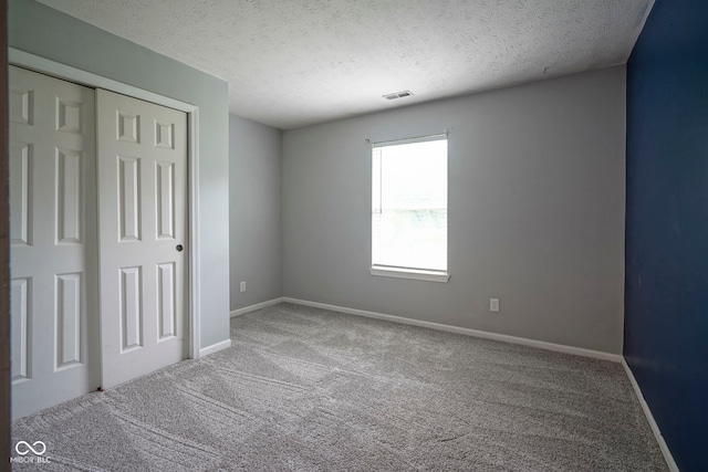 7724 Blackthorn Dr, Indianapolis, IN 46236 - unfurnished bedroom featuring carpet, baseboards, a textured ceiling, and a closet