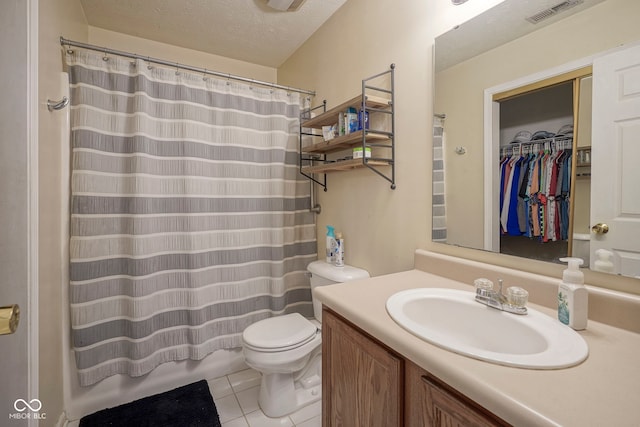 7724 Blackthorn Dr, Indianapolis, IN 46236 - full bath featuring tile patterned flooring, vanity, toilet, a textured ceiling, and a spacious closet