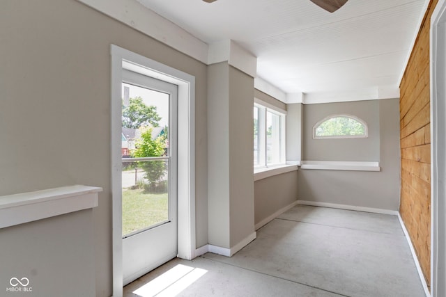 1150 W 30th St, Indianapolis, IN 46208 - doorway to outside with concrete floors, baseboards, and ceiling fan