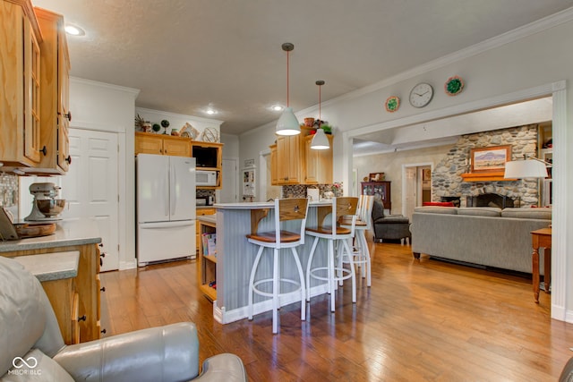 3533 Alexandria Pike, Anderson, IN 46012 - kitchen featuring white appliances, open floor plan, ornamental molding, a peninsula, and light wood-style floors